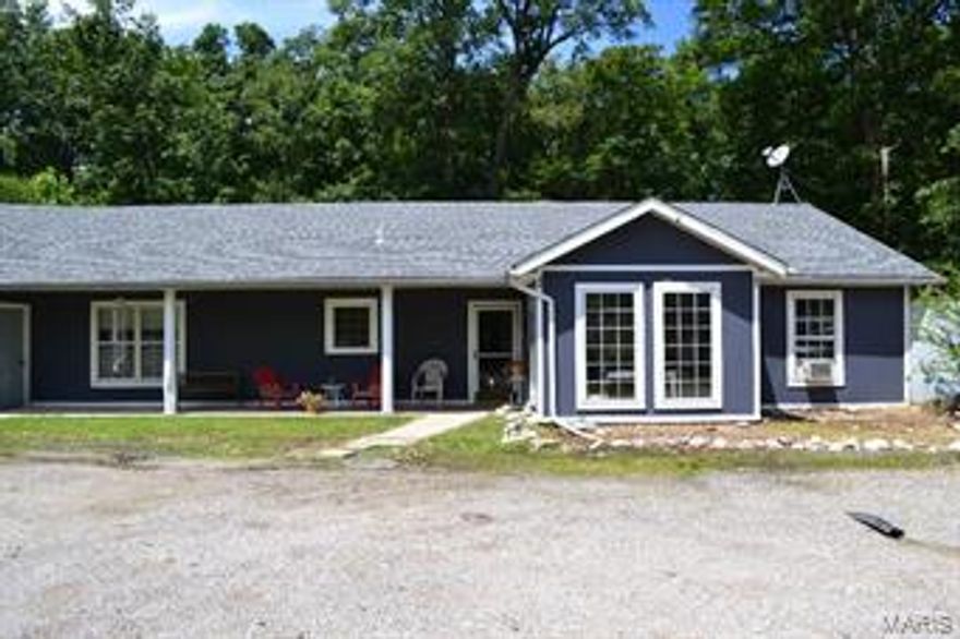 TWO FOR ONE! This cozy and efficient earth home is accompanied by a separate live-in suite. Have in-laws, older kids, family in town or need rental income?  This home is ideal! Nestled back on 4+ acres in the secluded Grandview Estates, this earth contact provides a spacious open and split bedroom floor plan. Large master bedroom includes master bath with separate shower and large soaking tub. All bedrooms are large and accompanied by huge walk in closets!  Kitchen includes a convenient breakfast bar with dining room and abundant cabinet space. New roof was installed in 2013 and brand new carpet throughout (Sept 2015) along with new sump pump system and wood burning stove (Aug 2015). The over-sized 35'x30' garage is just another bonus to this home! All entries are ground level and 36" which would make easy for any handicapped or elderly family members, all exterior and some interior doors are 36". Property backs to woods and is quiet and calm. 1 year HSA Home Warranty included. Additional Rooms: Mud Room, Sun Room