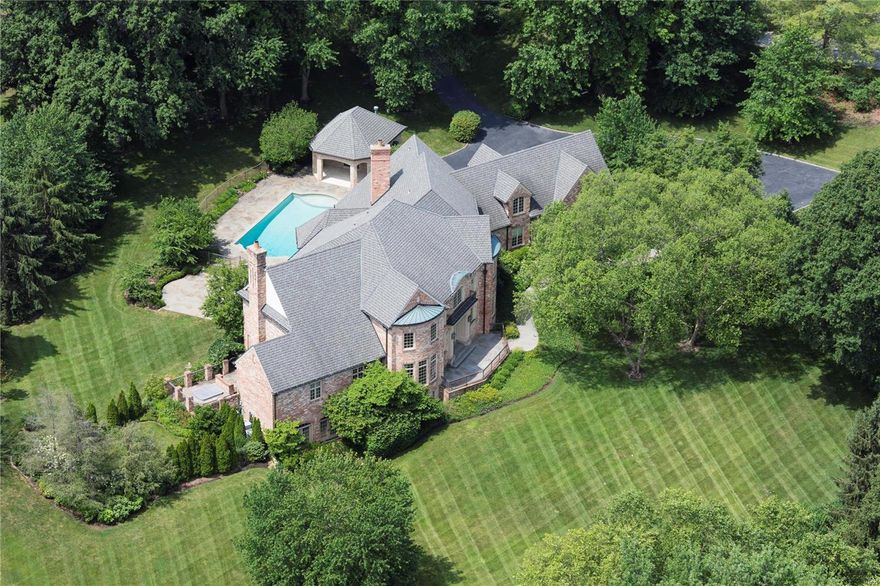 Situated on Litzsinger Road, the Gold Coast of Ladue, this New Orleans inspired estate property offers exceptional benefits of unique architectural design and designer finishes, and provides possibly the single best overall value of any estate in the surrounding area. Entry by way of brick monuments that lead to the breathtaking expansive and meticulous grounds, the setting is a tone of  meticulous creativity; landscaping is composed of mature  trees and pristine gardens. Defining point of the estate are the two-story living room with balcony, chefs kitchen with breakfast and hearth rooms, a main level Master wing, and magnificent outdoor entertainment areas, with Pebbletec saltwater pool, spa, pool house, flagstone decking and intricate wrought ironwork. The second level hosts three bedrooms and full guest apartment.  A home gym and media room complete the lower level. Built by Higginbothom Brothers, cost to recreate this remarkable property would surely double the offering price.