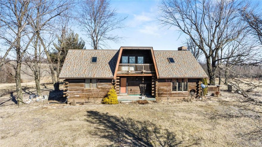 Beautiful views surround this 2100 +/- sq. foot log home. Situated on 3 acres this home offers three bedrooms and two full bathrooms. The great room offers a cathedral ceiling with a floor to ceiling stone wood burning fireplace. There are two main floor bedrooms and a main floor bathroom. The home also offers main floor laundry for added convenience. The upper level of the home offers the master bedroom with a full bathroom and a sitting area that over looks the family room below with amazing views of the countryside. From the upper level walk out on to the covered porch and enjoy the all the wildlife. 
The home also overs a full unfinished walk-out basement with a covered attached carport. .There is an additional 24 x 30 detached shop for all of your lawn and garden equipment.
Priced below appraisal.