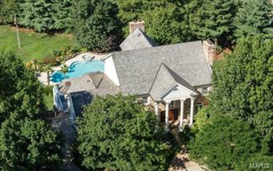 An exceptional and unique offering. Town & Country's best location, w/2 full acres on a private court of only 4 Executive homes. 6BD/5BA/7,200SF. Columned entry opens to sweeping double staircase. Details include historic light fixtures; the original crystal chandelier from the ballroom of the St Louis M.A.C.; a restored piece from a 1920's Hartford estate.  A vaulted, beamed Great Room opens to updated kitchen & brkfst room w/wraparound glassed deck. PebbleTec diving pool, real palm trees, fountain & waterfall create an oasis, complete with stone firepit, patios & terraces. Main floor Master Suite. Private Den/Office. 2nd level: 4BRs w/2 jack & jill baths. 2,300SF finished Walkout LL inc. BR suite, family room, theater, exercise room & bar. One full acre of level yard/play/garden space. New roof/gutters [2013]. Pool/decking redone [2015], Kitchen redone [2015], all 2nd floor baths redone [2015]. 24 zone Toro sprinkler system [2014]. Sonos Sound & intercom. In a word, perfect.