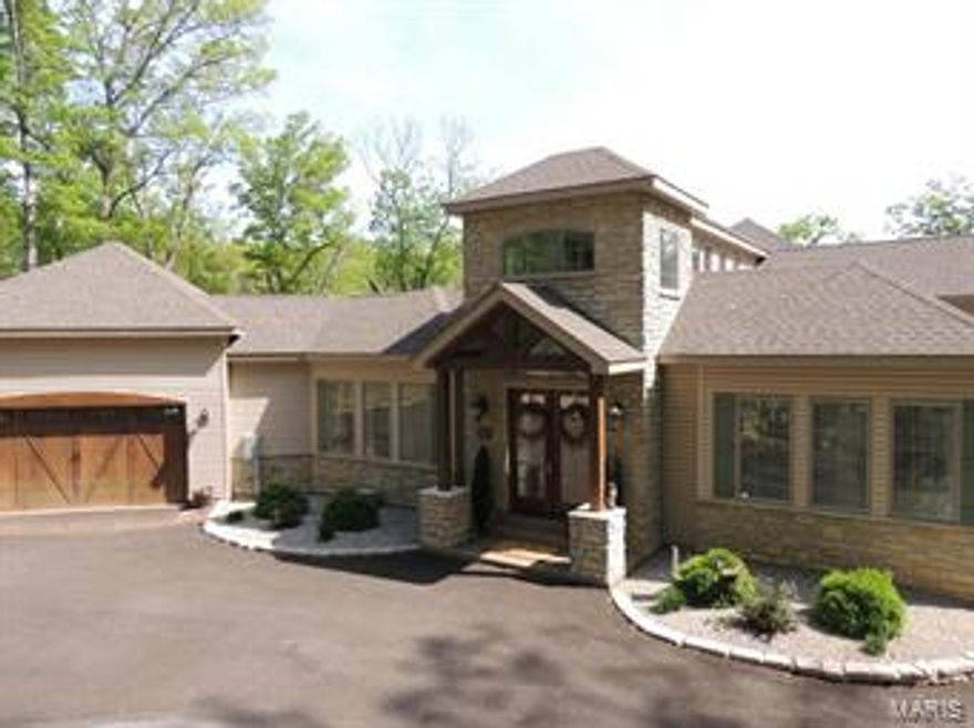 This is a stunning, one of a kind, custom home on Alpine Lake at Innsbrook. Designed for entertaining it features 4 large bedrooms each with a private bathroom. Perfect to host multiple families without feeling cramped. Marvel at the amount of natural light the Florida-esque style allows. You'll notice water views, trees, and light as you enter the 2-story foyer. The 100-yr-old clearstory stained glass windows were salvaged from a rural church built around the turn of the century. The custom kitchen includes stainless appliances, 2 dishwashers, marble countertops, and a large center island. The kitchen opens to the vaulted great room and dining area. A massive floor to ceiling fireplace adorns one wall. Enjoy morning coffee in the birds nest loft. The 2nd story views of the lake and woods are phenomenal. The lower level has a large living space with two bedrooms plus a wet bar. There are two private decks, a patio, and docking area on the lake. Alpine Lake is Innsbrook's largest lake!