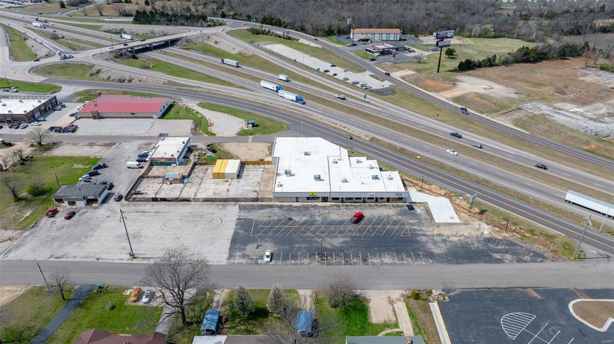 Excellent 1.5 +/- acre commercial lot and 20,000 sqft building located in a high traffic / visibility area of Sullivan, Mo.  The property sits just off I-44 and fronts both the service road and Fisher Dr.  
The property currently has occupancy in 3 units with 2 others currently in the process of being built out.  The owner is willing to assist in specific finishing of these two spaces.  The building has HVAC roof units that are all 4 years or newer as well as a 60 Mil TPO roof that was done in 2021. The owner is currently finishing out a game room, patio, and pickleball court on the north end of the building.  There is one loading dock that services 2 of the units and the parking lot has 45+ spaces.   Opportunities are endless here, from restaurants, retail, and office space to a gas station or hotel. Properties offering a combination of this size and location are becoming more and more rare.    There is additional acreage available. Owner financing would be considered with half down. Location: City, Corner Location, High Traffic, Hwy/Interstate Frntg, Retail Center