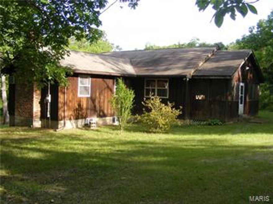 SECLUDED, NATURAL SETTING WITH LAKE ACCESS in picturesque valley near CONSERVATION LAND for hiking, boating, swimming, fishing, parks, & enjoyment! Spacious SUN-FILLED rooms, OPEN FLOOR PLAN ranch-style hide-away, with partial BASEMENT, only 15 years young!  Modern, TOTAL ELECTRIC home with vaulted ceilings, wood burning FIREPLACE, huge WRAP SUN DECK & large screened, covered porch. Comes complete with FURNITURE & APPLIANCES! Outside brick BBQ pit, picnic area, storage building, on 11 LOTS on both sides & rear (corner lot) PLUS a LAKEFRONT lot with DOCK. Water well & public sewer. PRIVATE LAKE DEVELOPMENT.