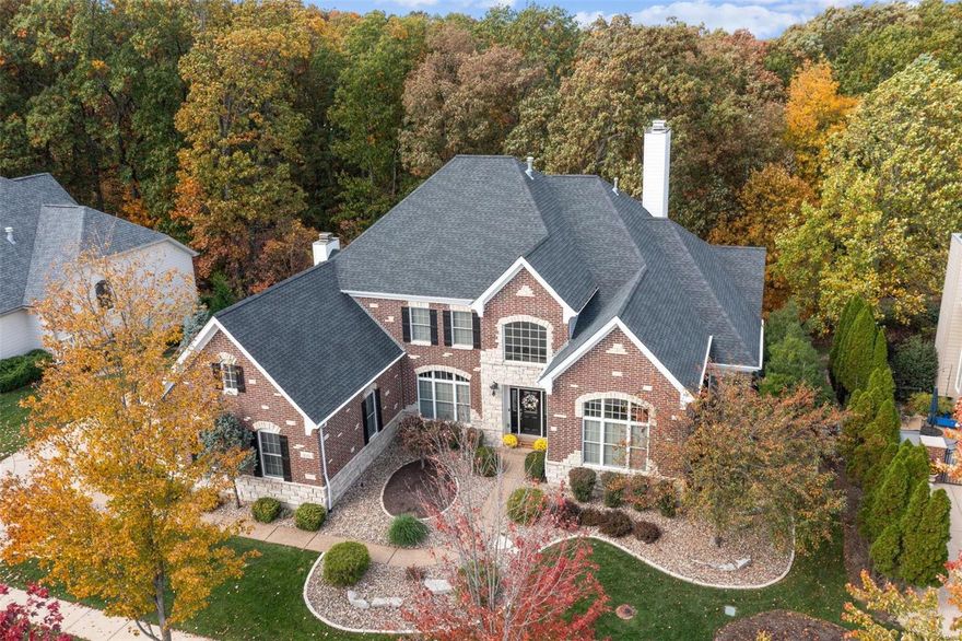 Welcome to this stunning 1.5 story home, meticulously crafted by Levinson Homes. Step into elegance through the 2-story foyer, setting the tone for the grandeur that awaits. The office features a 12' ceiling, providing a conducive atmosphere for productivity. Entertain in style in the great room w/custom bookcases, wet bar & fireplace. Culinary enthusiasts will appreciate the beautiful custom kitchen equipped w/convection microwave & oven/warming drawer, a 5-burner gas cooktop, a true chef's delight which seamlessly flows into the vaulted hearth room, w/gas fireplace perfect for cozy gatherings & relaxed evenings. Main floor master suite w/luxury bath. The upstairs features 3 bedrooms, w/2 sharing a J & J bath & one w/an ensuite. The walk-out LL w/ deep pour is an entertainer's dream w/custom bar, exercise room, bedroom & full bath. The exterior exudes curb appeal w/brick & stone on the front façade, newer Veka deck, patio, backing to trees, providing a serene & private backdrop. Additional Rooms: Mud Room