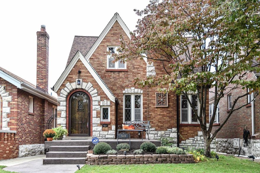 Welcome Home! Extraordinary curb appeal from manicured landscaping, stamped concrete, & outdoor lighting that delights in evening to highlight brick & stone details. Remarkable character & charm is present in wood trim/doors, stained glass, and elegant staircase. Gorgeous hardwood floors in entry way lead you into LR w/ fireplace as focal point and continue into large DR. Kitchen has ample cabinets & great natural light from the attached breakfast nook w/ counter/work space. 2 bedrooms w/ wood floors & full vintage bath complete main level. 3rd bedroom upstairs w/ walk-in closet & extra desk/writing area. Potential galore for huge storage area to be converted to your needs. Lower level features large family room, entertainment area, & wet bar. And wait, there's more! Luxury bath w/ jetted tub, separate shower and toilet room. Relax on covered backyard patio. 2 Car Garage. Updates: Roof '15, HVAC '15, PVC stack, electric panel, sewer lateral line(s), Water Heater(elec) '15, & more!