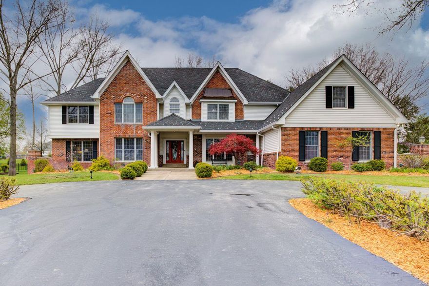 DeShetler built 1.5 story, 5000+ sq ft on 1+ acre. Beautiful 2-story Foyer & Great Rm with beamed ceiling, FP, wet bar, and double French doors leading to stone patio with built-in FP, providing an incredible entertaining area with expansive views of lush, private grounds. Off the Foyer is a wonderful wood paneled Library. The large, formal DR is perfect for holidays and family gatherings. The generous Kitchen with octagonal Breakfast Room is a chef’s dream, with custom cabinetry, granite countertops, large island and SS appliances. Beautiful Sun Rm off Kitchen w/skylights. The main floor Master Suite boasts CA Closets, Jacuzzi tub with separate shower, and separate vanities. Upstairs are 4 BRs with walk-in closets. Two BRs have ensuite Bths, while BRs 4 & 5 share a J & J Bth. There is also a Loft area which is perfect as computer space. The lower level with 9-ft ceilings has everything – Family Rm with FP, Game Rm, bar area, Wine Rm, Weight Rm, full bath and 2nd full Kitchen. Additional Rooms: Sun Room, Wine Cellar