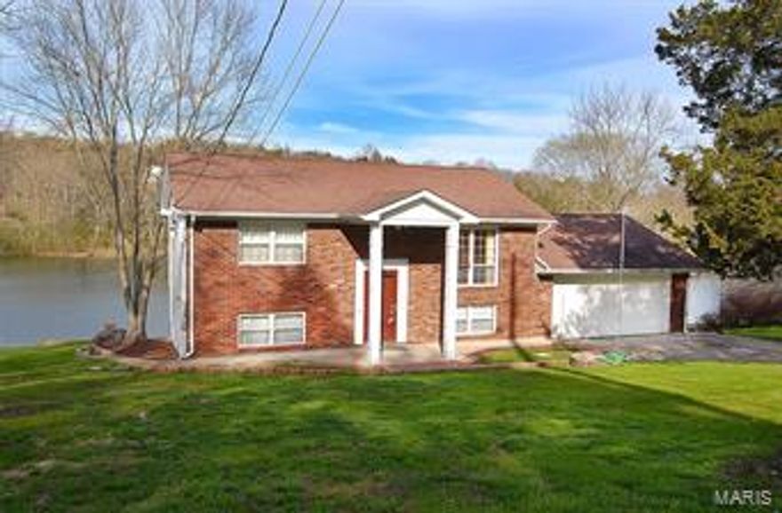 Vacation Living Year Round & close enough to drive to work! ** Fisherman's Dream w 10-13 acre lake in your Backyard! Watch  diamond like sparkles on the water from your Fam. Rm ,Kitchen, Master Bdrm. Surround yourself in Water views from the Sunroom! Enjoy Wildlife & Family BBQ's on the Lakeside Patio. Impeccably maintained family home w "Good Bones" *2 Lots* Oversized 2 car garage  **Thermal Wndws** Newer Arch. Style Roof**Brick Front w low maintenance vinyl siding/soffits* Large shed w electric *Sunny Open Floor Plan awaits your Decorating touch! Home being sold AS-IS and Seller prefers to do no repairs or Inspections. Home Warranty provided. Neighborhood is in the process of converting to Public Sewers in the very near future at future buyers expense.  For info on future sewer proposals and details go to www.jeffcopsd.org  Scroll down to Weber Hill/Warren Woods SSIA Project. Sq. ftg in tax records only 1 flr. *Confirm w lender availability of  USDA financing if interested