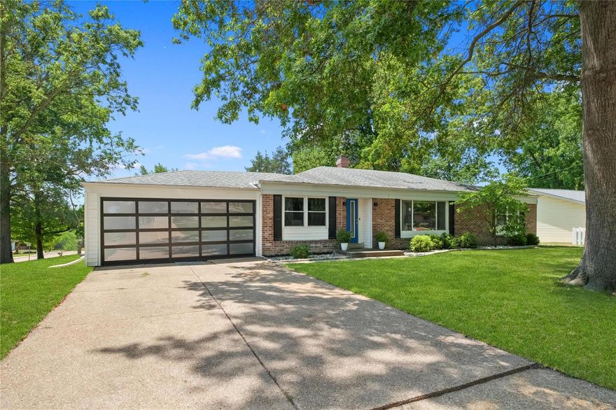 Elegantly Updated Mid Century Modern in Bellerive Estates! Clean lines, rich hardwoods, and designer fixtures will be your first impression of this upscale ranch.  A chef grade kitchen boasts granite tops, 42 inch cabinets, duo oven and SMART fridge. The family room with statement fireplace and the separate dining and living spaces have been professionally designed with modern details. The center hall plan leads to the primary en suite with double closets and updated shower bath with skylight. The two addl beds each have ample space and storage. Black marble hall bath is complete with new tub. The rod iron trimmed staircase leads to an incredible amount of finished space with XL recreation room, bonus room and bedroom, full updated bath in the walk out basement. Newly expanded patio areas, stone retaining wall and new fencing will make this your private retreat. PLUS electric car port, addl electric panel, sleek garage door, and security cameras make this 3300 ft home ultra modern.