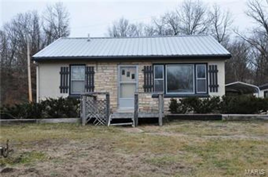 Cozy cottage on almost an acre right outside of town, RARE FIND!  Nestled up on a hill, this property includes a detached two car garage with storage/work area and concrete floors.  City water/sewer and metal roof. No subdivision association fees. Two bed, one bath, eat-in kitchen and large living room. This one won't last long! Additional Rooms: Mud Room