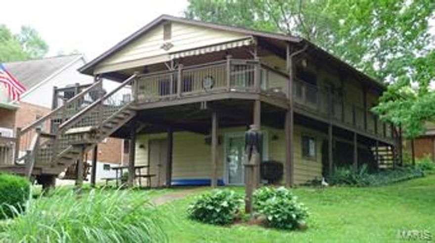 WATERFRONT HOME ON .6 ACRE LOT.  This property is located in a calm Cove 6 location with a great view toward the main channel of the lake. Great swimming in this area! The covered dock, martini deck, swim deck, boat lift and jet ski lift are waterfront features.  A partially covered wrap deck overlooks the water of this gently sloping over-sized lot.  Nicely updated, this home also features a fully finished walk-out basement with additional sleeping area plus full bath & utility area.  The 2-car detached garage with ample parking & storage area for a boat and a jet ski, are located behind the home. This home is being sold fully furnished with all of it's fine appointments.   The BOAT IS AVAILABLE FOR PURCHASE BY THE BUYER.  You will not find a home on the waterfront that has more to offer!