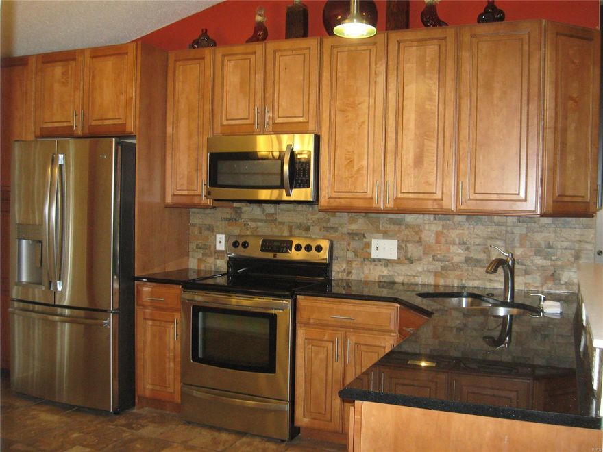 Affordable Remodeled 3 bdrm 2bath with lower level completely finished.  Vaulted ceilings & open floor plan / kitchen opened up to living room make perfect for hosting get togethers.  Living space feels huge!  Kitchen recently remodeled to include SS appliances, 42" custom cabinets, granite counter-tops, fixture & ceramic flooring sliding glass door off kitchen to backyard.  Walk-in cedar closet located in LL were possible sleeping area could be utilized.  Two more separate areas in LL could be used as media/sitting room & or Rec rooms.  Some newer windows throughout & light fixtures.  Ceiling fans in all bdrms. New paint throughout house.  Ask your Agent about possible credits/concessions.  **Very motivated Seller so hurry - otherwise could be gone quick!**