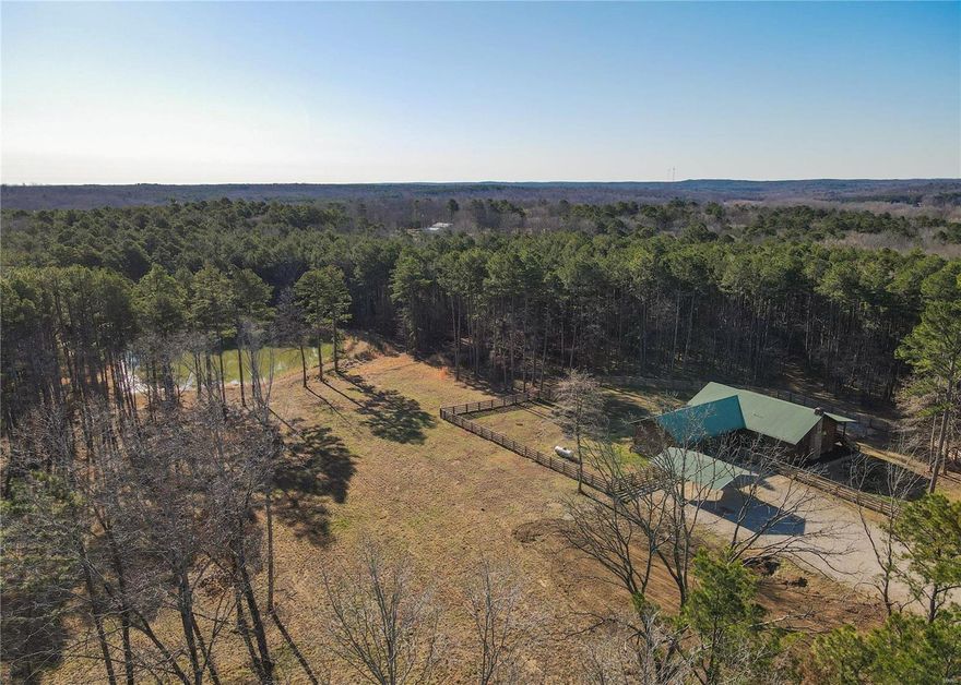 Welcome to your own private estate at the edge of town! Beautiful custom 4 bed, 3 bath, 3556 +/- sqft home on 37.25 acres bordering thousands of acres of National Forest. Remodeled kitchen featuring granite countertops and backsplash, exposed beams, and hardwood floor throughout. 2 beds/2 baths upstairs, the master suite featuring a walk-in closet, marble shower, soaking tub, and granite countertops. The fully-finished walkout basement includes 2 beds, 1 bath, custom fireplace, storm shelter, and beautiful wood ceiling made from lumber cut on-site. Spacious, fully-fenced yard with 7 gates. The stocked pond attracts tons of wildlife: turkeys, deer, geese, turtles etc. The large wrap-around deck covers 2 sides of the home offering ample space for enjoying your own private view of nature. Established trail system for hiking/UTVs. Barn/workshop with 220v power and propane heat. Paved access, just 1.5 miles to the school and other amenities. Homes like this don't hit the market often!