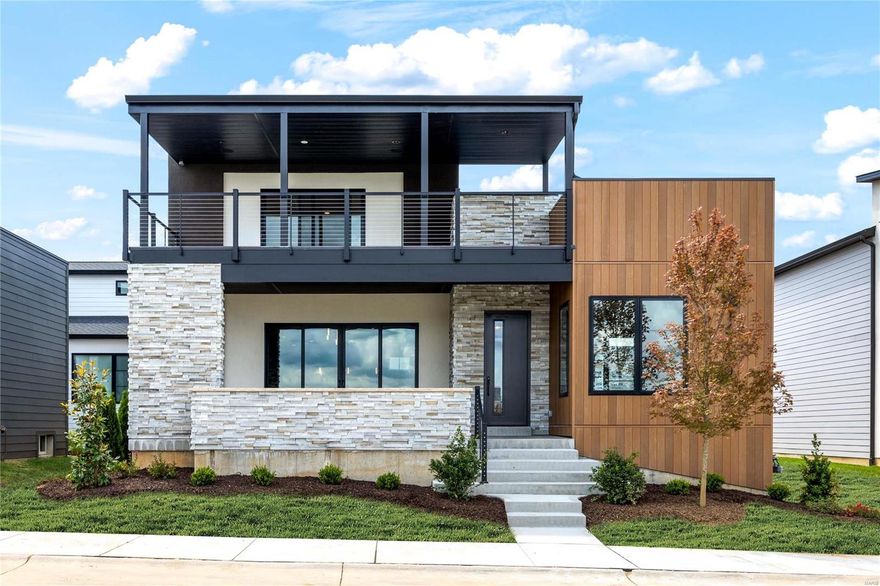 New construction in Chesterfield’s prestigious Waterfront at Wildhorse Village. With approximately $1,000,000 in builder upgrades, this sophisticated Contemporary redefines luxury living. Open floor plan features 10’ ceilings, wide plank flooring, designer lighting & expansive windows that offer perfect views of the community lake. Inviting lanai leads to impressive entry foyer, private study, stunning great room highlighted by floor-to-ceiling linear fireplace, adjacent dining room & state-of-the-art kitchen with quartzite countertops, commercial grade appliances & 10’ center island with waterfall edges. Spacious primary bedroom suite with spa-like bath provides an appealing retreat. The 2nd floor extends the living quarters with a 2nd ensuite bedroom plus 2 additional bedrooms, hall full bath & bonus room that walks out to covered deck. Lower Level includes recreation room, 2nd kitchen, 5th bedroom & full bath. Premium waterfront lot with private outdoor living areas & 3-car garage.