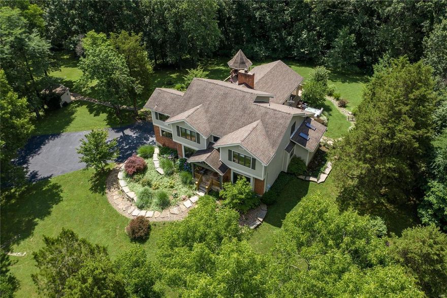 Spectacular custom home on nearly 9 acres of lawn, fenced pastures & woods for an abundance of privacy! 6100+ sqft of TLA, including a 2000 sqft addition by the current owners. Enter to find the dining rm & a study w/ French doors. The spacious 2 story hearth rm boasts a fireplace & wet bar. The gourmet kitchen features granite, tile backsplash, top of the line ss appliances & adjoining breakfast rm w/ French doors to the deck. 1,000 sqft Great rm w/ vaulted ceiling & 5 Amish crafted timber frame trusses, fireplace, walk-behind bar & 3 French doors to the lg wrap-around deck. ML master w/ access to the deck & hot tub, 2 w/i closets & bath w/ double sinks, tub & w/i steam shower. 3 addtl bedrms, full bath & bonus rm/possible 5th bedrm on the UL. W/o LL is perfect for entertaining w/ family rm, game rm, wine cellar, exercise rm & full bath. Addtl features: patio, gazebo, geothermal HVAC, 3 car garage, hay barn, 2 stall barn for horses, conveniently located near Babler Park & more! Additional Rooms: Wine Cellar