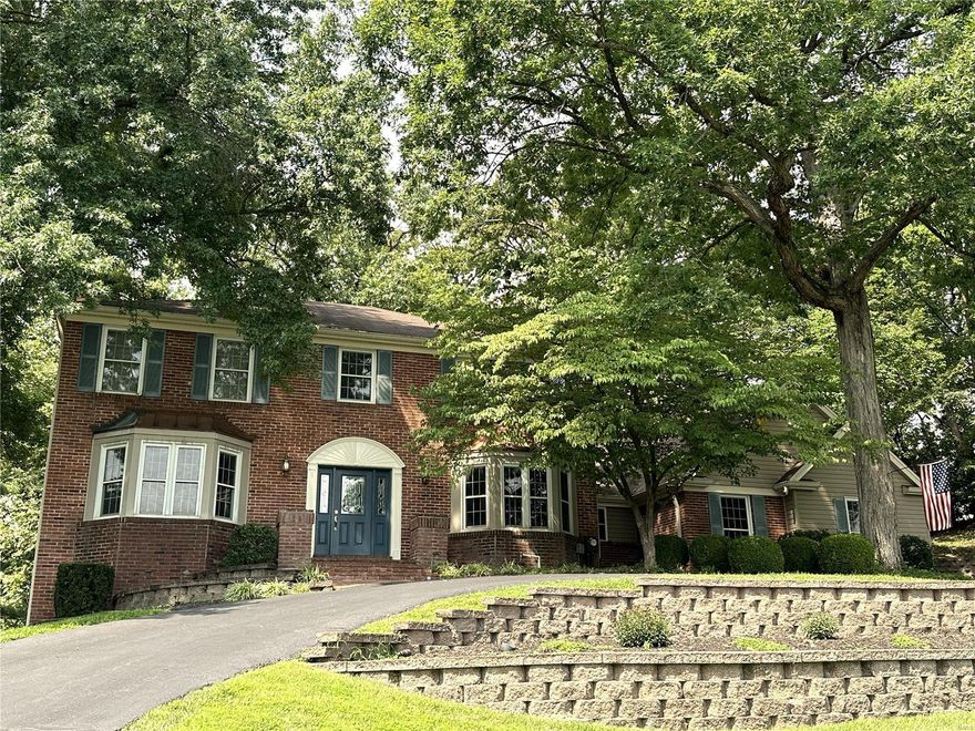 WOW 2 STORY HOME IN DESIRABLE FOREST HILLS!! BACKS TO VALLEY COURSE! APPROX 5,000 SQ FT TOTAL LIVING AREA. SO MANY UPDATES & FEATURES & MAJOR ADDITION CREATING OPEN FLOOR PLAN! Beautiful hickory floors thru-out main level. Updated kitchen-6 burner gas cooktop w/hood, warming drawer, Dacor appliances, center island, softclose drawers & doors. Opens to the lg brkfst room w/lots of windows overlooking the beautiful treed backyard! Main floor has so much entertaining space-large great room w/beamed ceilings, built-ins, brick fireplace, additional sitting room AND LARGE BAR AREA perfect for game day get togethers. Sep dining & DEDICATED OFFICE on main level. Updated walkout LL-rec room & game room perfect for relaxing, watching a movie or playing games! Wet bar, fireplace, 1/2 bath, large storage closet + unfinished storage too! Updated primary bath, 3 HVAC zones, circular drive, 3 car side entry garage, lg patio & deck. Easy walking distance or take your golf cart to the private club!