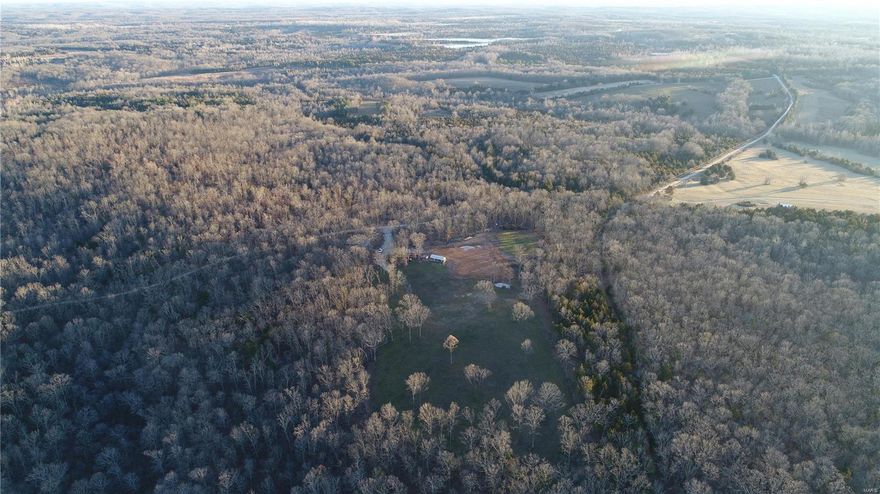 This mostly wooded property consists of 50+/- acres of hardwood timber and a recently cleared 5+/- acre area for a future home site, pasture, and/or a large food plot. There is an existing private well on the property and electric is at the corner of Deer Valley Rd. and Thunder Ridge Rd.  The property is also equipped with an ATV trail system, wet weather creek, additional food plots site, and a second gated entrance on Thunder Ridge Rd. This property is apart the Lake Forest Farms community that includes access to a 32+/- acre lake. The HOA fee is $150 annually and covers road and lake maintenance. There are restrictions, but they are limited. Mobile or manufactured homes are permitted on this lot, as well as ATV’s, UTV’s, hunting, trapping, and non-commercial livestock. There is an additional 25+/- acres available for sale adjacent to the subject property to the north.