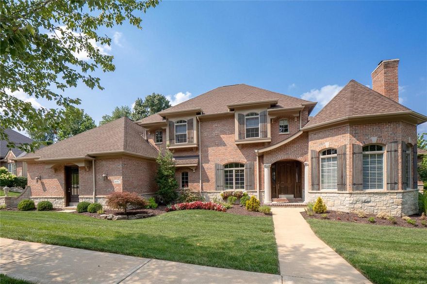 Exceptional 1.5 story home built by Flower Homes. Incredible architectural details throughout including arched doorways, beamed ceilings, curved walls, extensive millwork, bowed bay windows with columns, tray ceilings. Impressive home office with stone fireplace and beamed ceiling. Kitchen updated with custom cabinetry, huge center island/breakfast bar and equipped with high-end stainless steel appliances. Breathtaking hearth room exudes rustic elegance with a floor-to-ceiling fireplace and stunning vaulted/beamed ceiling. Sophisticated main floor master suite includes his/hers walk-in closets and a master bath designed for pampering with a double vanity, stand-alone soaking tub and oversized glass & tile shower. Upper level offers three bedrooms, two full baths and an extra bonus room. Finished lower level with large recreation room, wet bar, 5th bedroom and a full bath. Don’t miss the vaulted screen porch with stone fireplace and the charming patio with built-in fire-pit. Like new!