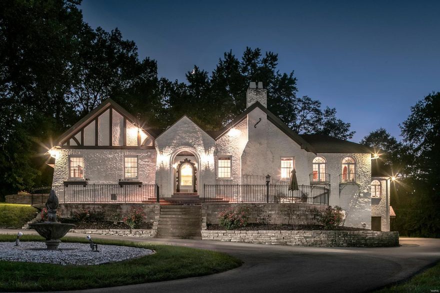 A Frontenac Oasis with Dramatic Spaces! One of the Most Interesting Architectural Homes on the Market!  4 Bedrooms, 3 Full & 2 Half Baths.  Nearly 3 Acres of Mature Trees, Lush Grounds with a Tennis Court. Terrazzo Floors, Decorative Moldings, Palladium Windows, Art Nouveau Sconces, Decorative Ironwork are Some of the Special Features Found in the Home.  The Grand Room Features a 14’ Coved Lit Ceiling & a 6’ Wood burning Fireplace.  French Doors Lead to Light Filled Red Oak Paneled Vaulted Great Room w Dentil Molding w Wet Bar & Access to Private Patio.  Relax in ‘The Sanctuary’ A Lovely Space w Ornate Imported Italian Tile Fountain as the Focal Point.  Eat in Kitchen has an Attached Breakfast Room w Bay Window, Custom Pantry w Pull Out Shelving & Butler’s Pantry. Great for Entertaining! Luxury Master Suite w/ Custom Closets, His/Her Vanities & Commodes, Separate Soaking Tub & Shower.  Main Floor Laundry.  Basement w Incredible Amounts of Storage, Exercise Area & 4 Car Garage. Additional Rooms: Sun Room