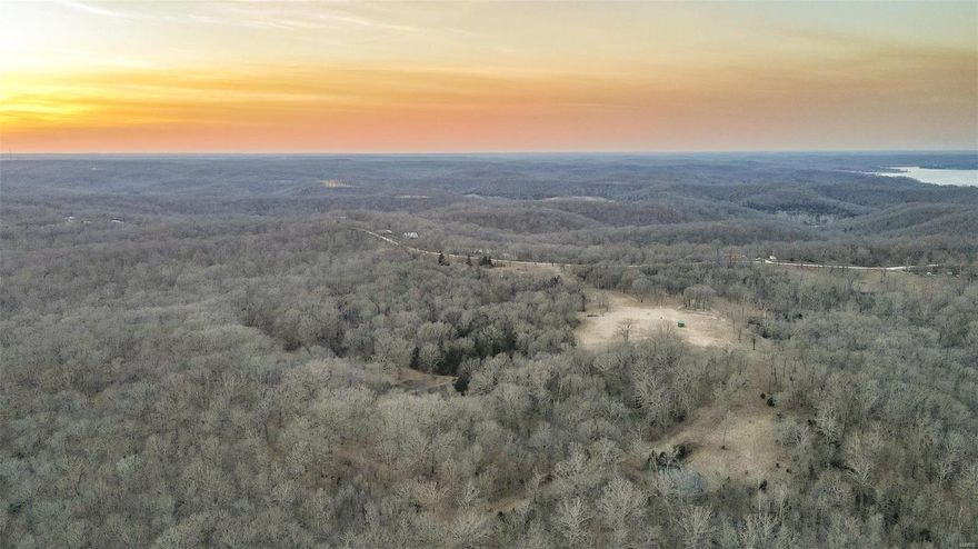 150+ acres at Lake of the Ozarks! This property sets up great for the ultimate hunting tract and just about anything you may have in mind. Consisting of diverse timber with fields, ridge tops, valleys and creek bottom. Multiple food plots are frost seeded and ready for spring. Electric and a well are already in place along with some perimeter fencing and a nice gated entrance. A wet weather creek flows through the property, along with a pond. There is also a small water hole in the timber providing another great water source for wildlife to use. Deer and turkey are abundant. The lay of this land is ideal for the Ozark area with an extensive interior and perimeter trail system allowing for ease of getting around its ideal topography. It's also very suitable for horses. If you are looking to build a home on acreage at the lake, or maybe you already have a lake house and need that large recreational tract to make your lake life more complete, come check this place out.