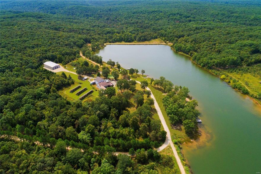 Rare opportunity to own approximately 256 very private acres surrounding a glorious 30 acre Lake.  Peace, tranquility and natural beauty along with countless recreational features create the perfect haven for today's busy life.  The compound includes two connected lake houses with private entrances and utilities, one of which was built with a private elevator to all 3 floors.  Multiple decks overlook the property and lake.  Most of the power is supplied by large solar panels on the property.  The 30 acre stocked lake features a sand beach, a boat dock and a screened tree house.  There is a par 3 golf course, hunting range and so much more!  See the attached video and special features sheet. This unique property has been the private getaway for a large St Louis family since 1986 and can now be yours to make a lifetime of memories. Please provide 24 hour notice for showings - call Connie or Maria. Some Accessible Features