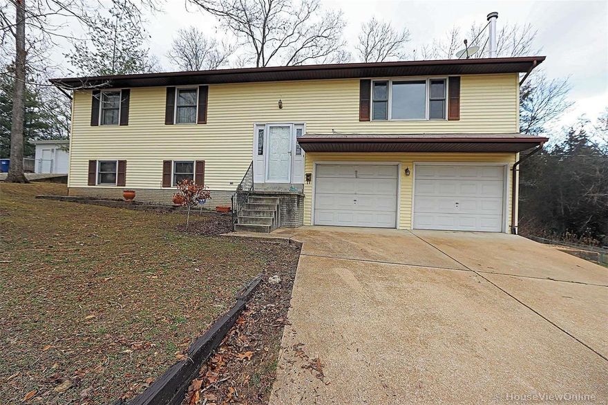 Large home with over 2,200 sq. ft. on a corner lot with a fantastic view of the Lake across the street. This home has 4 bedrooms, 2 1/2 baths, large master bedroom with bath. Large family room, large laundry and 1/2 bath in the lower walk out level. Storage shed and fenced back yard. Large deck off of the kitchen area with french doors. 2 car attached garage. Great location!