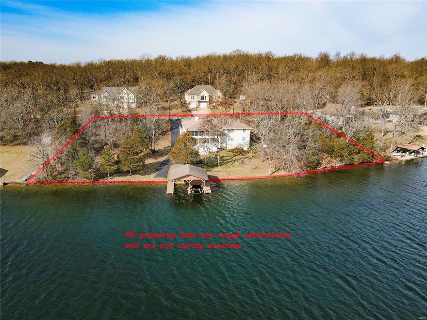 ONCE IN A LIFETIME opportunity to own over 1 acre with more than 350 ft of lake frontage on the largest ski lake in Terre Du Lac.  Over 3800 sq ft of living space, 4 Bedroom, 4 1/2 Bath, 3 car garage home situated in the middle of three lots providing amble privacy and opportunity.  Main level features master bedroom suite with separate his and her bathrooms, office (possible 5th bedroom), main floor laundry, separate dining room, living room with wood burning fireplace and a 3 seasons room overlooking the lake.  Walkout basement is the perfect place to host guest. Basement includes 3 bedrooms, 2 full baths, kitchen, family room and plenty of storage. Enjoy the convenience of your own boat ramp and double slip boat house with lift and storage. Other attributes to the home include lake fed irrigation system and all home Generac generator. Terre Du Lac features 15 lakes, golf course, club house, river access and much more. Additional Rooms: Sun Room