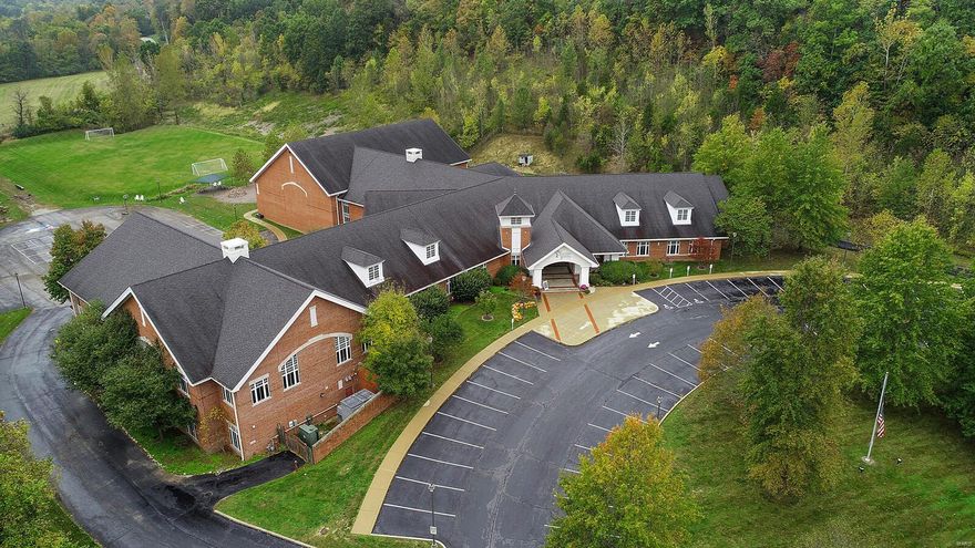 Seeking a unique Commercial Opportunity in St Louis MSA?! Look no more, as this Stately, architecturally designed 60,000 sqft Full Brick Structure boasts 12+ acres, 60+ parking spaces, and Prestigious location in St Albans Village.  At main entrance, the covered driveway entrance features a sitting area and access to the main common areas, like Keeping Room, Kitchen and Dining area, Administrative Offices, Conference Room, Music Room, Art Room, & Library. Grand stairwell connects these common areas of the main floor with the main & lower private rooms. There are 15+ private rooms all of which offer large windows for natural light & water access, whether a bathroom or sink. It's these spaces that make this property potentially perfect for repurposing into residential condos, a retirement community, or hotel.  The 10,000+ sqft Auditorium with stage, bleachers, restrooms, & separate access could be perfect for hosting events, conferences, or weddings. Call to Look & begin Imagining Today! Location: Rural