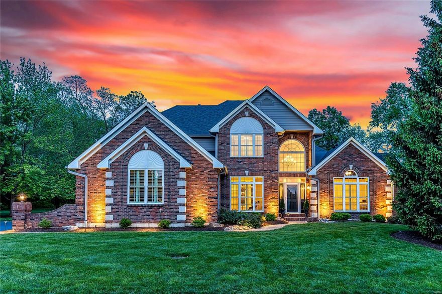 Distinctive design elements including soaring ceilings, detailed trim work, palladian windows & oak hardwoods are featured throughout this spectacular brick & stone 1.5 Sty. Impressive 2-sty foyer w/architectural columns leads to well-appointed study with built-in work center, formal dining room & stunning great room highlighted by dramatic wall of windows. Designer kitchen with 42” cabinetry, granite countertops & stainless steel appliances adjoins light-filled breakfast room & exceptionally large hearth room with floor-to-ceiling brick fireplace. Coffered primary bedroom suite w/ luxury bath with jetted tub offers an appealing retreat. Open staircase accesses 3 additional bedrooms, 1 with ensuite bath & 2 with Jack n’ Jill bath. Lower Level entertainment space includes recreation room plus 5th bedroom & full bath. Situated on a private .86-ac lot w/ open & covered patios & pool. Golf community lifestyle with access to clubhouse, pool, tennis courts & 36-hole championship golf course.