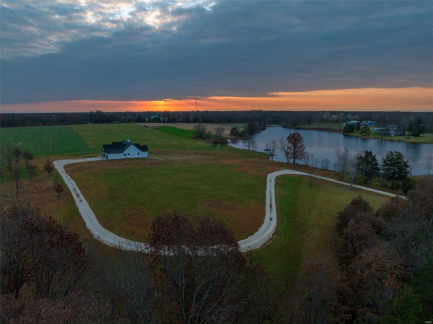 48 hour kickout! Stunning new construction home on 12 unrestricted acres that fronts a 20+- acre lake! No detail was overlooked. The kitchen features quartz counters, custom cabinets and a massive island to anchor the space. Living room has a vaulted ceiling and heat n glow woodburning fireplace with stone surround. Quality finishes like Anderson casement windows and solid Hickory flooring. Enjoy the view of the lake from the covered back porch. Owners' suite is large and also has a vaulted ceiling, 12x8 walk in closet. Bathroom has double sinks, a freestanding hammered copper tub and a shower with double showerheads. Two more bedrooms, full bath, half bath and main floor laundry round out this level. The basement level is bright and airy, thanks to it being mostly finished, large doors and windows open to the lake view. Full 2nd suite, Second kitchen, half bath, office - perfection! Tuck under garage would be an awesome pool room or pet washing area. 2 miles to Hwy 70, don't miss it!
