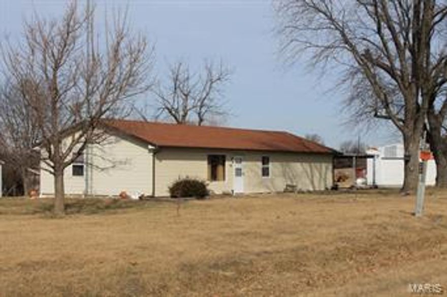 Motivated Sellers, Make offer!!! This cozy ranch home is surrounded by larger tracts of land and has blacktop frontage on State Highway NN. Beautiful wood stained doors and trim work, granite and stone counter tops in freshly remodeled bathroom and picture window overlooking rolling country side make this a hard place to beat for country living.  The big bonus comes with the 30 by 60 outbuilding with 2 separate work areas and finished office space in between with its own propane furnace.  In addition there is another 20 by 50 foot barn with a loft and concrete floor.  Large covered back porch lets you sit in the back and enjoy the afternoon country breeze.  This tidy 3 bedrooms, 1-bath, 1,440 sq. ft. home offers easy living with a great location. Located less than 2 miles from Interstate 70 and minutes from town for easy access.  Not part of a subdivision and no subdivision assessments or rules.
Outside wooded burning furnace DON’T OPEN door.