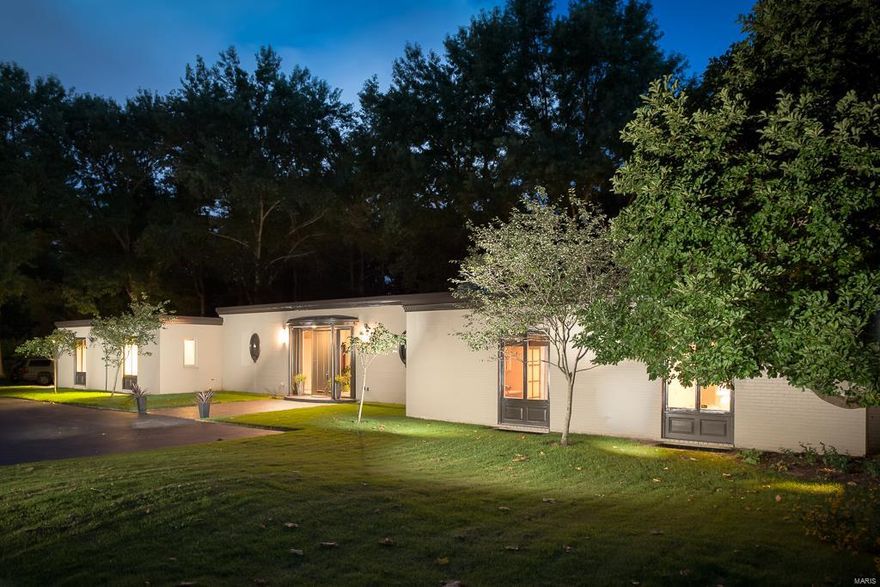 Contemporary living on 1.8 acres on a prestigious lane in Ladue. This home offers privacy and sophistication in a dramatic setting.  The foyer and living room feature marble flooring and dramatic 10 ft ceilings.  The kitchen has been updated with state of the art appliances, center island and abundance of cabinets.  The adjoining breakfast room is adjacent to the family room which provides as access to the patio and pool area. The master suite incorporates a luxurious bath, dressing area and huge walk-in closet and an adjoining office/study. Three additional bedrooms are spacious and have private baths. The lower level has been partially finished and includes a fitness area, recreational area, sitting area and bath.  All this and still plenty of storage. A virtual wall of windows provides beautiful views of the terrace, pool and garden.  Truly a hidden gem.