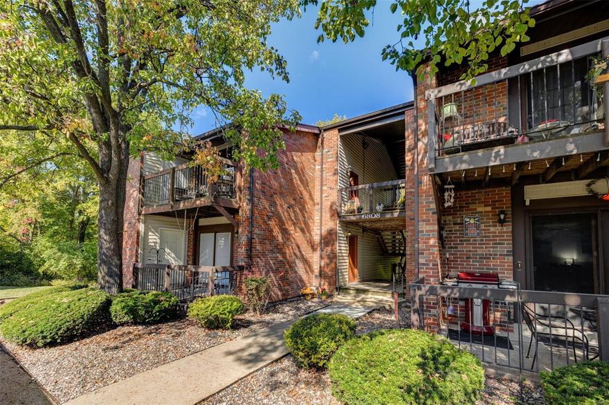 Upper level brick condo with vaulted ceilings that backs to common ground and woods in desirable New England Village. 2 beds, 1 bath and in-unit laundry w/stackable washer/dryer that stay. Open floor plan w/living room featuring woodburning fireplace, vaulted ceilings, and slider to storage room and private deck overlooking woods. Breakfast room with vaulted ceiling and ceiling fan just off kitchen w/electric range, garbage disposal, dishwasher, pantry and refrigerator that stays. Owner's suite includes expansive closet, and amazing wooded view. Second bedroom and full bath with in-unit laundry. 6-panel doors and a covered parking spot. Short walk to clubhouse, tennis courts, basketball court and pool for annual fee of $325. Monthly condo fee of $208 includes water, sewer, trash, snow removal, lawn/landscaping, etc. Oakville schools and close proximity to restaurants, shopping and retail. Location: End Unit, Upper Level