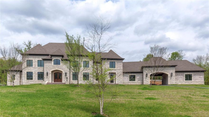 This magnificent European-styled Estate home features over 10,000 sf of living space enhanced by superb craftsmanship & distinctive architectural elements. Expansive 2-sty hardwood foyer highlighted by  dramatic sweeping staircase leads to library-paneled study, beautifully appointed dining room & stunning great room with 12’ box beam ceiling, slate fireplace & wet bar. Exceptionally large kitchen with commercial grade appliances, granite countertops, extensive cabinetry & 10’ x 6’ center island adjoins vaulted breakfast room with bank of windows & hearth room with stone fireplace & atrium doors to screened porch. Coffered master bedroom with dressing area & lavish bath offers a relaxing retreat. Front & rear staircases & elevator access 4 additional bedrooms, 2 with ensuite baths & 2 with Jack n’ Jill bath, & 2nd floor laundry. Walk-out Lower Level includes recreation room, workout room & full bath with sauna. Situated on 2.5 ac grounds with patio, pool, porte cochere & 4-car garage. Additional Rooms: Mud Room