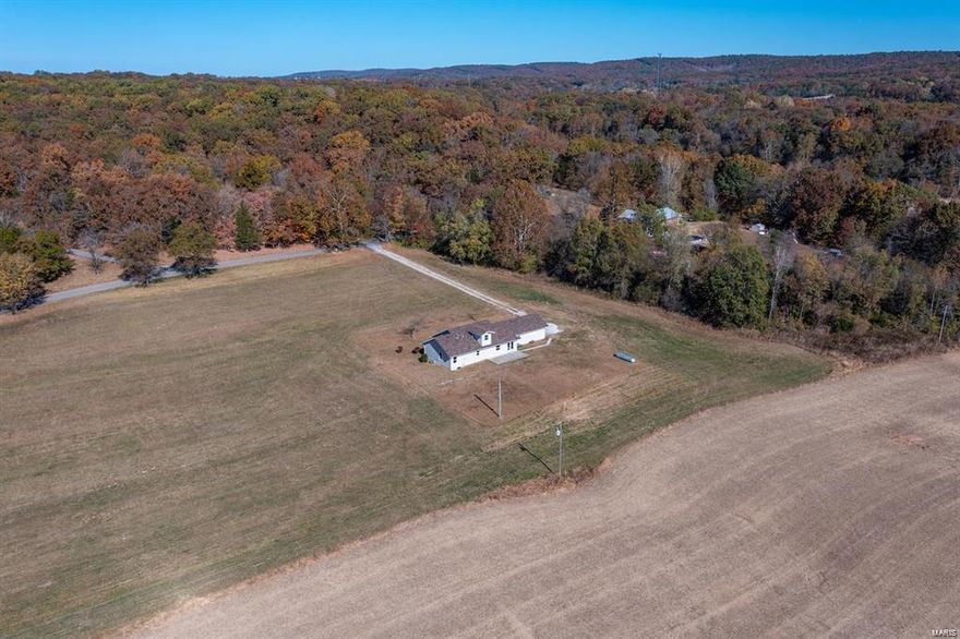 5.92 level pasture ground, a lot of road frontage. 1.5 story Ranch with 4 bedrooms, 2 full baths, open floor plan, cathedral ceilings, side load oversize 2 car garage. Within the last few months roof replaced, carpeting, paint, garage door, main floor laundry and master bedroom. Kitchen with appliance staying, walk in pantry, breakfast bar, large breakfast area! Put this one on your must see list!
