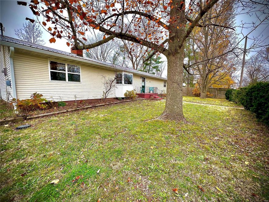 3 bedroom 1.5 bath ranch style home sitting on a corner lot! Walk into a spacious open concept kitchen/living room with wood burning fireplace. A family or bonus room on the south end of the home. Kitchen has custom made maple cabinets & breakfast bar. All appliances: Refrigerator, Range-electric w/double oven, built-in microwave, dishwasher will stay. Between the kitchen & garage entry is a nice sitting/sun room. Hardwood flooring throughout the home. Laundry room has plenty of shelf space and could double as pantry. Primary  bedroom has 1/2 bath & freshly painted walls. 2 nice sized bedrooms, one having 2 closets. The main bathroom was remodeled in 2017 & hosts a Jacuzzi tub/shower, lots of cabinet space. Metal roof put on in 2016, vinyl siding on the exterior of the home was put on in 2007. Covered porch off the backyard, both front & backyards are fenced. Front yard has lots of perennial flowers & large shade trees. Beautiful property close to schools, downtown & shopping areas! Additional Rooms: Sun Room