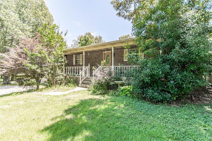 This quaint 4 bedroom 2.5 bath home is located just south of town right outside city limits. It sits on 2.87 acres and has a detached two car garage. The living room is open and very spacious with a rocked wood burning fireplace centered to walk around. There's a jack and jill bathroom that has a tiled jacuzzi tub. The full walk out basement is great for a rec room/game area. There's a spacious sunroom that also has a door to stairs that walk down to the back yard. The large covered front porch is the perfect setting for a porch swing! $195,900. Additional Rooms: Sun Room