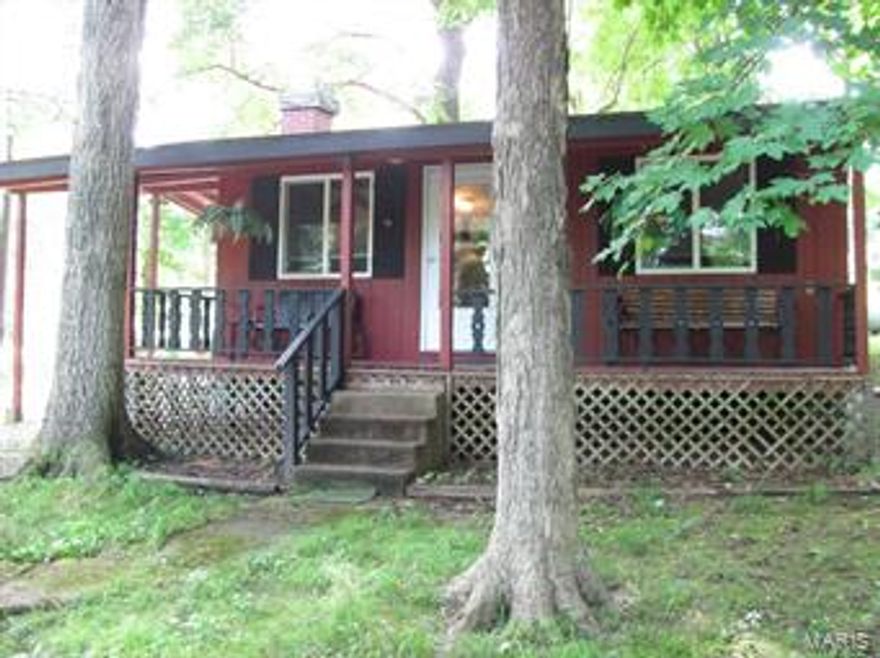 H1805 - Cute weekend get away or year round 1 bedroom home situated on 5 lots. Whether heated by either a 30,000+ BTU wall furnace or the pretty propane stand alone fireplace, this well insulated cabin will stay warm and toasty all year long.   The current owner has been busy keeping his retreat up-to-date with newer carpet, windows, sliding door, drywall, insulation, floor tile,......well you get the idea.

With the Meramec River right across the street, this home offers a scenic retreat from daily life as you sit on your covered porch and watch the wildlife that's close by.  This is the closest home to the River and the Park's Gazebo while still being out of the Flood Plain.  Want to get away from it all?  Take a look at this little hide a way.