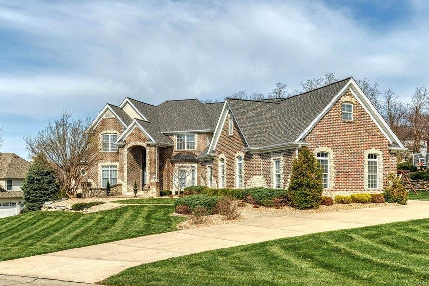 Spectacular 1.5-sty Estate home with over 7000 sf of living space enhanced by superior craftsmanship & distinctive architectural elements throughout. 2-Sty marble foyer leads to private study, elegant dining room framed by arched entryways & stunning great room with dramatic 2-sty bay window & cast stone fireplace flanked by display cases. Designer kitchen with granite countertops, maple cabinetry & premium appliances adjoins breakfast room with bay window & planning center & vaulted hearth room with floor-to-ceiling stone fireplace. The master bedroom suite offers an appealing retreat with 2 walk-in closets, lavish bath with jetted tub & access to patio. The 2nd floor extends the living quarters with 3 additional ensuite bedrooms, family room, bonus room & laundry. Walk-out Lower Level includes recreation room with fireplace & wet bar, game room, 5th bedroom & full bath. Situated on a 1+ ac cul-de-sac lot with pool & patio with firepit surrounded by landscaped gardens & 4-car garage.