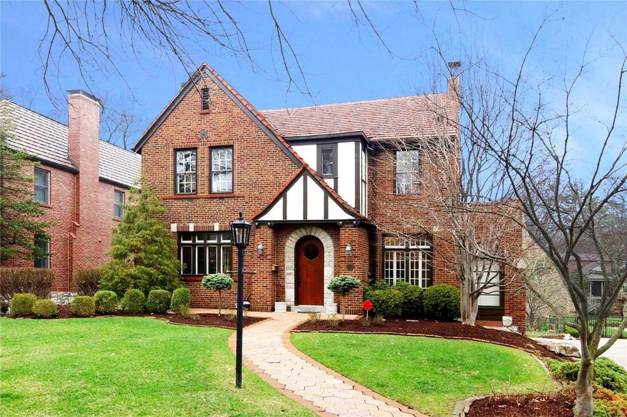 *Showings begin Sun. April 8 Open House, 1:00-3:00.* Beautiful red brick two story tudor home located in sought after Claverach Park, featuring 4 bedrooms, 2.5 baths & situated on a lovely lot offering a large private back yard with tied deck. Light and bright this home boasts a wonderful floor plan, 1st floor includes a step-down office/den with fireplace & built-in desk, living & dining room, large family room with fireplace, built-in bookcases & walls of windows overlooking yard. Professionally designed eat-in kitchen, white cabinetry, high-end appliances includes an induction range & granite counters, ample storage. The 2nd floor includes a spacious Master Suite with organized closets, updated private bath with heated floor, additional 3 nice-sized bedrooms & updated full bath, one of the bedrooms has an attached room being used as a library, built-in shelves. 2 separate garage bays with additional storage. Enjoy all that Clayton has to offer, walking distance  to Clayton schools!