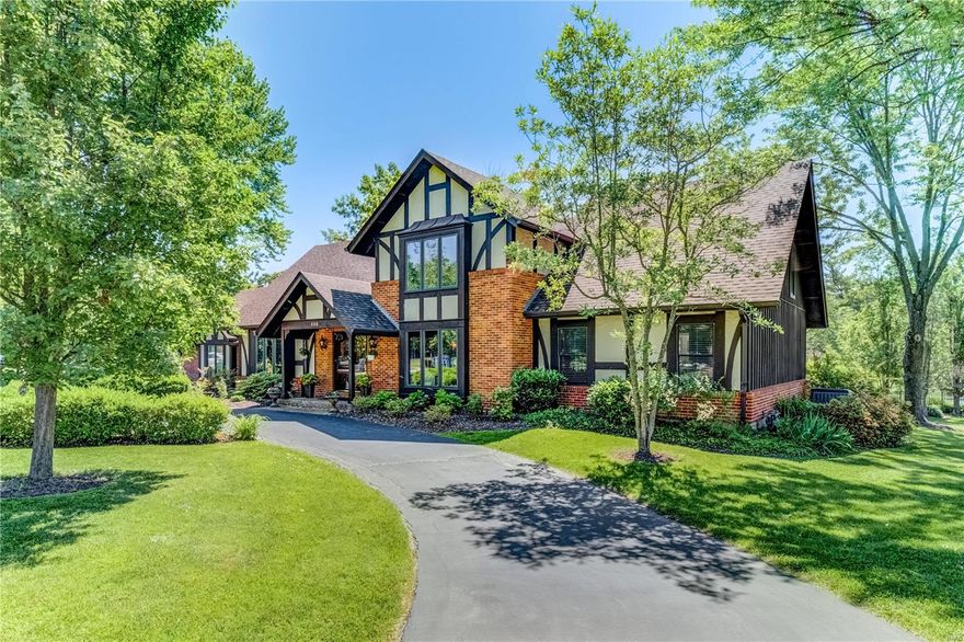 Pull into a beautiful tree-lined neighborhood in one of Creve Couer's premier subdivisions that includes stocked lake & parklike grounds. Conveniently located near all major highways with easy access to downtown St. Louis, Airport, and more, perfect location for commuters, yet tucked into a subdivision that is serene and away from all the noise. This classic Tudor style 1.5 story home, not only offers ample indoor space but includes an amazing lot (.905 acres) with beautifully kept grounds and your own private in-ground pool that offers an expansive decking where you can enjoy hosting your new neighbors, friends, and family. This home is perfect for those who like to entertain both inside and out. Highlights include: Updated eat-in kitchen w/center island, SS appliances, coffee bar, main floor laundry, vaulted great room with access to pool, wood burning fireplace, circle drive, rear entry garage, finished lower level, heated floors, wet bar, pet fence, neutral color palette and more.
