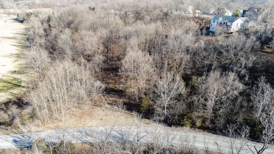 Stunning 3+ wooded acres in Paradise Valley! Exclusive golf course and gated community. Build your dream home! Public water, sewer and electric on site! Award-winning Rockwood School District!