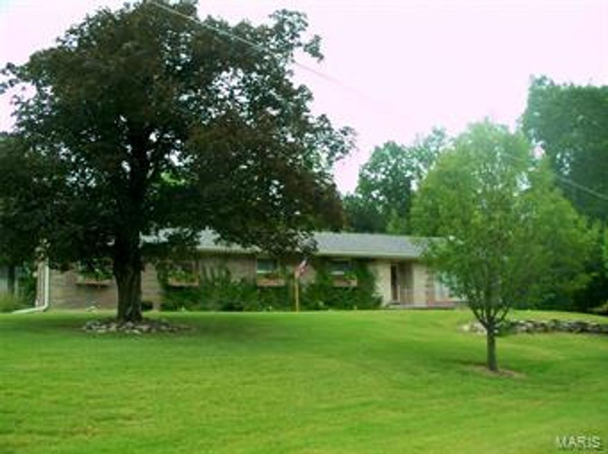 Custom quality brick construction. Beautiful mature landscaping & curb appeal in this sought-after location.  Entry foyer with foil wall covering leads to sunken living room, which features a gas fireplace & extra large picture window.  Dining room has beautiful mirrored wall and opens up to the kitchen and living room.  Kitchen features ceramic tile counter-top, nice pantry, and eat-in area.  Third bedroom on main floor with garage entrance could be an office. Lower level 31'x21' family room has 2nd gas fireplace and would make the ideal theater room.  Second kitchen features original vintage refrigerator and range.  Sleeping room w/laundry area, hobby room, full bath and abundant storage complete this level.  Delightful partially covered patio with a built-in gas grill is an ideal place to entertain family and friends.  Gorgeous flowers and landscaping always compliment the patio on one side and private secluded woods on the other side. Two-car garage w/work area & even more storage.