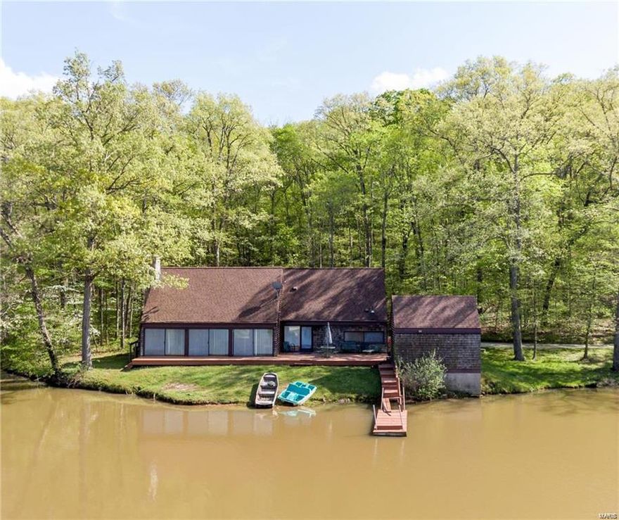 If you're looking for privacy and seclusion you've found it here! This property is the perfect weekend retreat and features a 1.5 story home with 3 bedrooms and 2 baths. This is all nestled privately on 117.88 wooded acres in the heart of Augusta wine country with a stocked 9 acre lake.  You can enjoy views from the deck, the dock or just sitting in the great room with large windows overlooking the lake.  You'll be cozy in the winter too with the stone fireplace to keep you warm.  There are wood floors and wood cathedral ceiling to add to the cozy setting.  There's also the option of building your own custom home!