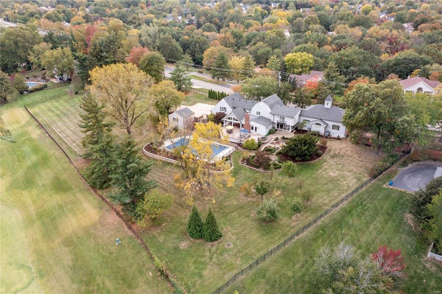 Witness the Estate of 2654 Valley Road, originally a schoolhouse, residing on 2.2 acres overlooking the 6th hole of Valley Course at Forest Hills. This 1.5 story home features 4 bedrms, 3 full & 2 half baths, spacious 5,888 sq ft, sauna, 3 family rms w/ 5" wood flooring &  Master wing complete w/ private brick courtyard. The master suite w/ grand chandelier, pecky cypress walls, spa bath, & WIC adjoins custom Library loft w/ built-in cabinetry & cupola. The chef's kitchen offers 2 sinks & dishwashers, Sub zero fridge, granite counters overlooking the dining rm w/ scenic views through the oversized windows/sliding glass doors. Upstairs boasts 3 bedrms, family rm w/ gas f/p, vaulted ceiling & beams, & sitting rm. Entertain in style in hearth rm w/ wood burning f/p offering more views of the covered deck, fire pit area w/ water feature & patios overlooking the 27X52 in-ground heated pool. Gated drive w/ 5 car garage parking, on a lush, mature professionally landscaped lot. Welcome home! Additional Rooms: Mud Room