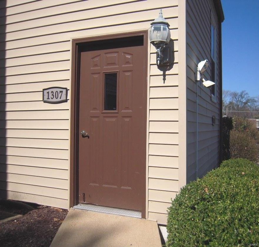 Attractive 2 bedroom 2 bath ground level condo in such a convenient location. Entry foyer with a closet.  Updates include: Pella Slider doors in the living room and the master bedroom, and porcelain flooring in the kitchen.  In addition, the following has been updated since the current seller's ownership: Champion windows except there is a Cardinal window above the kitchen sink, dishwasher, disposal, kitchen range, microwave, hot water heater, and crown moulding.  SPACIOUS Kitchen.  Living room\dining room combo.  Walk-in closet in the MBR. All Electric. Stacked washer and dryer stays.  1 car garage. Covered patio to enjoy.
Storage area off patio.  Backs to a private residence. Location: Ground Level