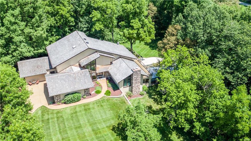 1.5 story 6br/5ba custom Estate Home on 4.2 acres in a very private park-like setting in PRIME CHESTERFIELD LOCATION. 7,720 sf of TLA plus 2,552 sf of covered & uncovered concrete decks & patios. 2 BRs currently used as home offices. Indoor-outdoor pool. 7 person Aspen spa. 18” travertine tile floors. Large kitchen has 30 custom solid cherry wood cabinets & 17 drawers. Granite countertops & backsplashes. Breakfast room. Dining room. 2 Great rooms. Finished lower level. Exposed aggregate driveway, turnaround & sidewalks. #1 heavy wood shake roof. Lawn sprinkler system. Private Road - no through traffic. Numerous species of mature trees. Some white oaks are over 200 years old. Abundant wildlife. This OUTSTANDING LOCATION avoids heavy traffic - only minutes to/from highway 40/64, shopping & dining. 10 minutes to 40/270 & major hospitals. This custom home is perfect for entertaining your family & friends. Horses permitted. COOL: 14 SEER+