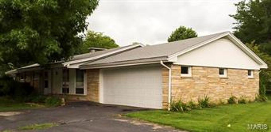 Home for sale in Hermann Mo! Ranch style home within walking distance to park and schools! This 3 bedroom 1 bath family home is move in ready. Beautiful stone veneer on the exterior, some wood floors on the interior and a wood burning fireplace in the dining room gives this house the perfect bones for a charming home after a little updating. Let the designer be YOU!!  Property sits on 2 city lots and has a full basement and attached 2 car garage.
