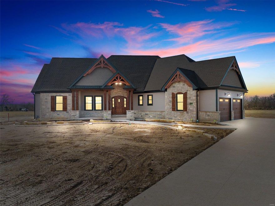 This stunning home very near completion - only odds and ends remain and will be completed soon! Absolutely gorgeous lot with new landscaping, an outdoor kitchen, huge covered patio and beautiful stone fireplace. The yard is screaming for a pool! The home features an oversized 3 car garage and loads of custom stone and cedar on the exterior. Upon entry you will find a large great room, dining area/kitchen that welcomes you immediately. The vaulted ceiling features custom exposed wood trusses and a floor to ceiling stone fireplace with"isotherm" gas firebox. 10 ceilings throughout with a few trays and vaults to add to the dramatic height.  The kitchen features custom cabinetry, a huge center island and GE Monogram appliances. Elegance abounds throughout this split floor plan - 4 beds, 3 12/ baths with a custom finished basement complete with wet bar area. This home is loaded with special features and needs to be seen!