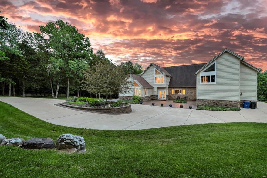 Unique 1.5 story sprawling home on THE MOST pristine 4.81 acre lot in all of Eureka! This gorgeous property is situated across the street from picturesque Pevely Farms Golf Course & includes extensive landscaping, patios, retaining walls, circle drive & more. Almost the entire lot is serviced by an irrigation system that draws water from your private well. Walk inside to over 5K square feet of living space, soaring, architectural windows, vaulted ceilings, 2-sty entry w/exposed staircase & TONS of natural lighting. Gourmet kitchen is improved w/granite counters, 42 in cabinets, recessed lighting, SS appliances, custom back splash, large center island/breakfast bar & dining area. Family room is accented by a wood burning stove w/full brick surround, wet bar & built in cabinets. FR & formal DR provide amazing spaces for entertaining guests & family. Main floor MB suite includes a large MB. Upstairs you'll find 5 HUGE BR's & 1 full bath. Finished LL W/O has a rec/media room & full bath.