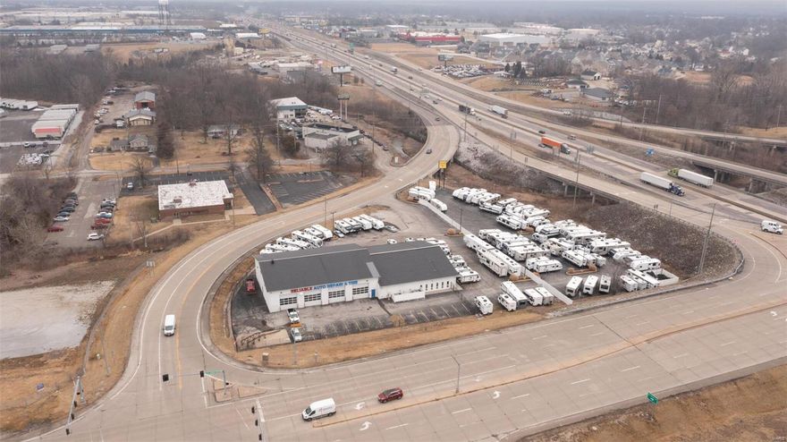 New Price!!!  The opportunity to purchase this kind of property does not come along very often.  Located at the intersection of I-70 - TR Hughes - East Terra Lane, you have hard corner exposure with drive by and visibility on all 4 sides.  Building is in great condition and well maintained with 9 automotive bays, new insulation in the ceiling, 8 new 14' x 14' garage doors/operators with glass panel inserts, new fire protection system, 2 new big air fans in the service bays, new LED lighting in shop, heavy electric in the shop, new gas fired air heaters in the shop.  Priced at only $230sf this property should sell quickly.  Try to buy the land and build for that price.  Fixtures available to purchase.  Need equipment for your garage.  Lets talk.  We could set this up as a turn key business.
Car Lot and front offices are leased out to a solid tenant.  Please ask for additional details.
Seller might also consider a lease with the right terms for the shop and reception area. Location: Corner Location, High Traffic, Hwy/Interstate Frntg